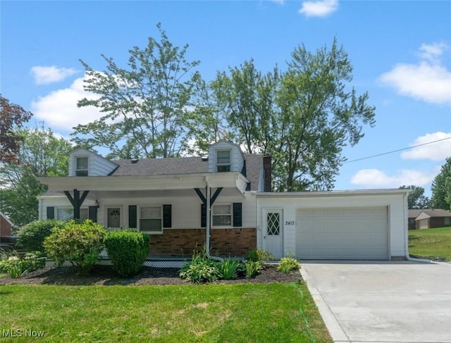 2413 W Manor Ave, Struthers, OH 44514 - cape cod-style house with driveway, a garage, a front yard, brick siding, and a chimney