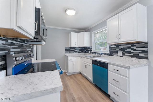 2413 W Manor Ave, Struthers, OH 44514 - kitchen featuring dishwashing machine, ornamental molding, stainless steel microwave, decorative backsplash, and light wood finished floors