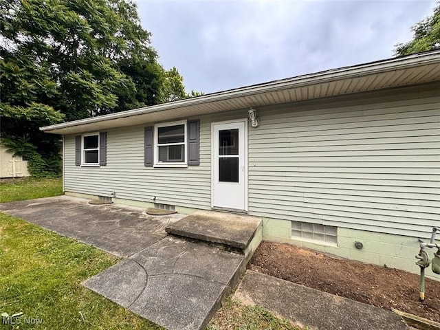 1587 Hilda St, Lakemore, OH 44250 - doorway to property featuring a patio area