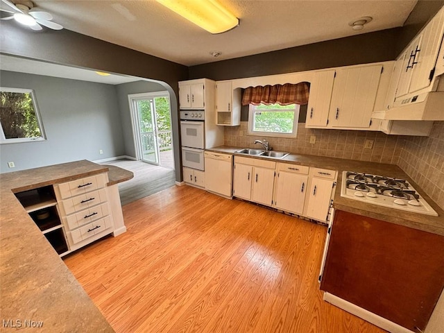 1587 Hilda St, Lakemore, OH 44250 - kitchen featuring white appliances, light wood finished floors, healthy amount of natural light, and under cabinet range hood