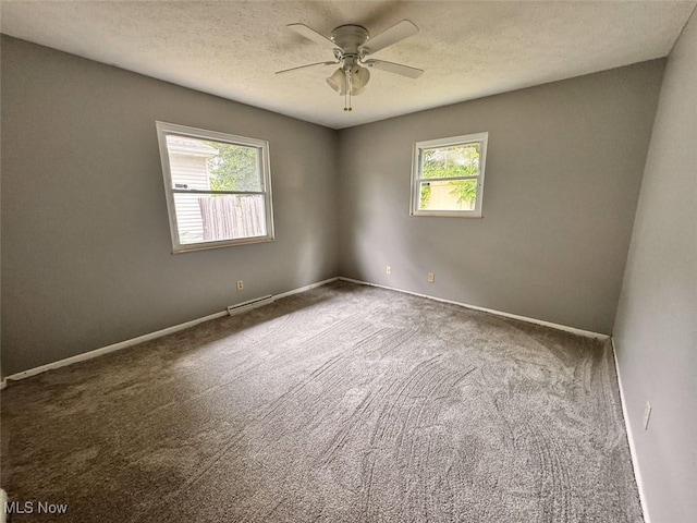 1587 Hilda St, Lakemore, OH 44250 - unfurnished room with healthy amount of natural light, a ceiling fan, carpet floors, and a textured ceiling