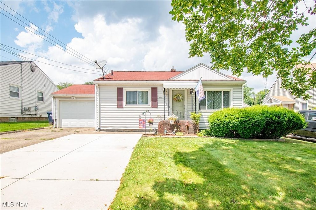 119 Clinton Ave, Akron, OH 44301 - view of front of property with concrete driveway, a front yard, and a garage