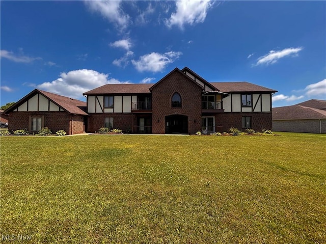 931 Pearson Cir Unit 3, Boardman, OH 44512 - rear view of house featuring a lawn, brick siding, and a balcony