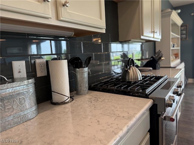 3508 Boos Rd, Huron, OH 44839 - kitchen view of stainless steel gas range, backsplash, and white cabinetry