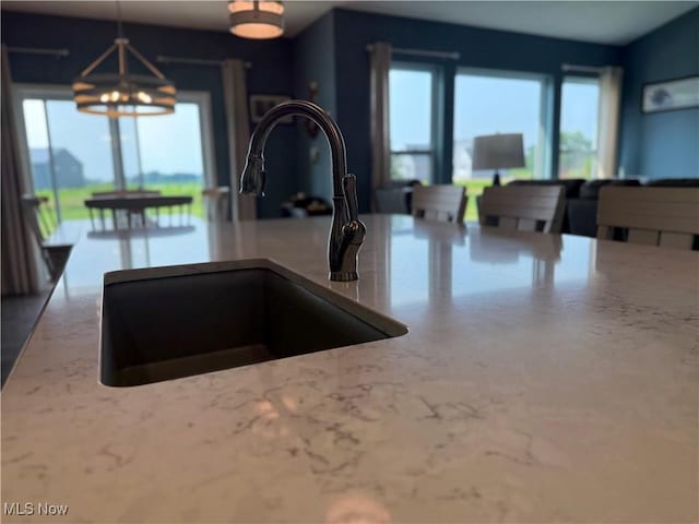 3508 Boos Rd, Huron, OH 44839 - kitchen with light stone countertops, pendant lighting, and a chandelier