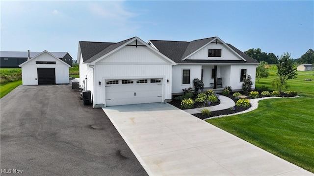 3508 Boos Rd, Huron, OH 44839 - modern farmhouse style home with a front yard, covered porch, an attached garage, and concrete driveway