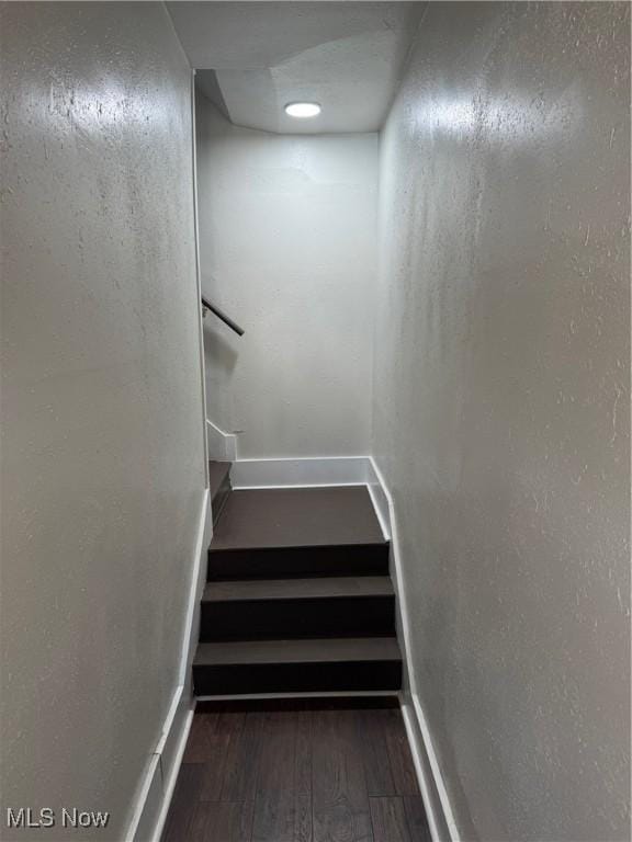 703 Locust St, Coshocton, OH 43812 - staircase featuring hardwood / wood-style floors and baseboards