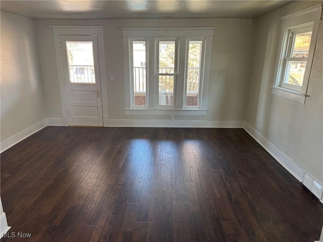 703 Locust St, Coshocton, OH 43812 - foyer entrance featuring dark wood-type flooring and baseboards