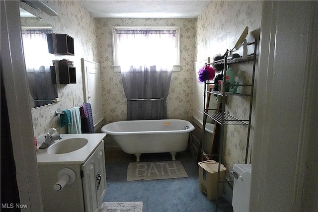 2171 15th St SW, Kenmore, OH 44314 - bathroom with wallpapered walls, vanity, and a soaking tub
