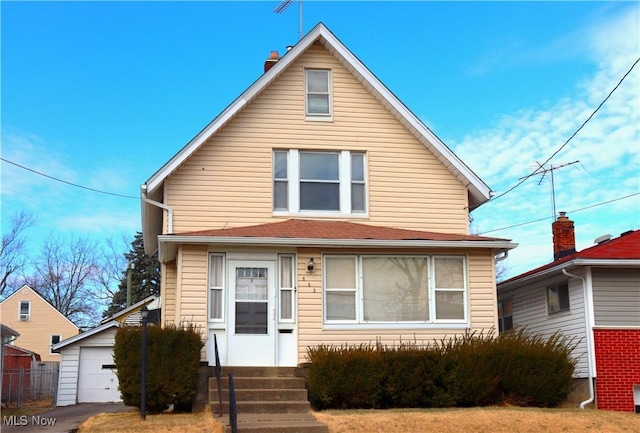 2171 15th St SW, Kenmore, OH 44314 - view of front facade featuring an outbuilding, a detached garage, a chimney, and entry steps