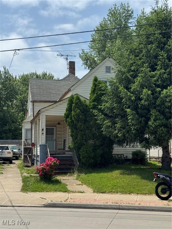 3454 Fulton Rd, Cleveland, OH 44109 - view of front facade featuring covered porch, a front yard, and driveway