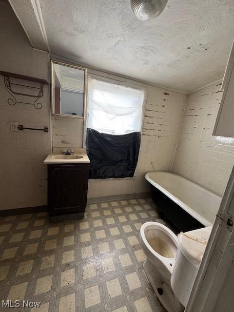 3454 Fulton Rd, Cleveland, OH 44109 - bathroom featuring tile patterned floors, vanity, a freestanding bath, and a textured ceiling