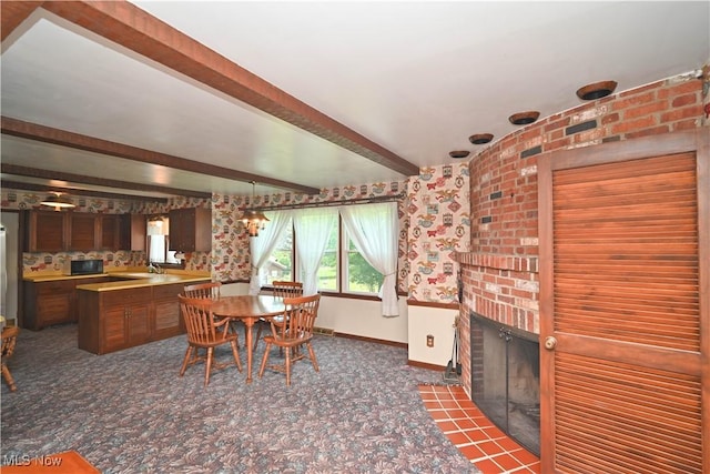 5735 Herbert Rd, Canfield, OH 44406 - carpeted dining space with beam ceiling and a brick fireplace