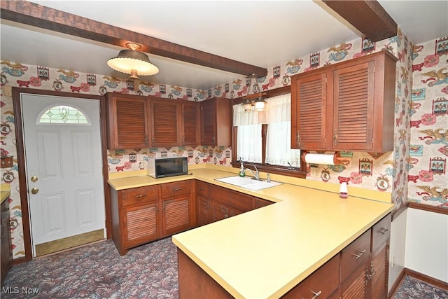 5735 Herbert Rd, Canfield, OH 44406 - kitchen featuring wallpapered walls, black microwave, beam ceiling, light countertops, and a peninsula