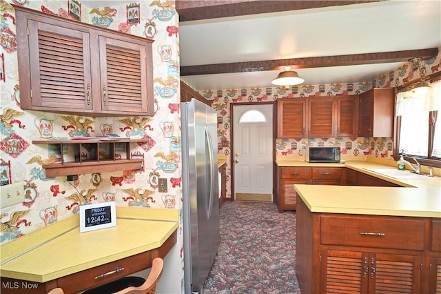 5735 Herbert Rd, Canfield, OH 44406 - kitchen with freestanding refrigerator, wallpapered walls, black microwave, light countertops, and a peninsula