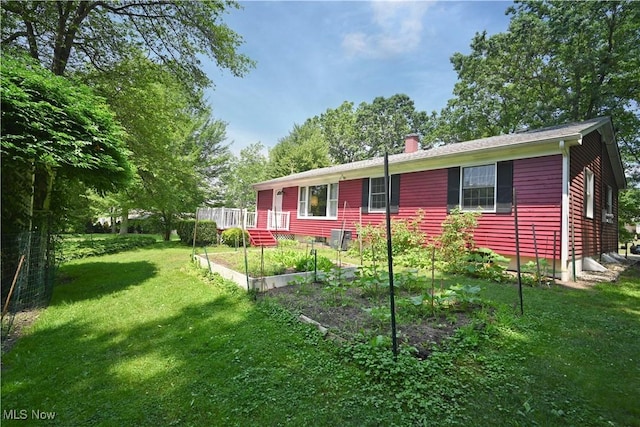 5735 Herbert Rd, Canfield, OH 44406 - view of front of property with a garden, a front yard, and a chimney