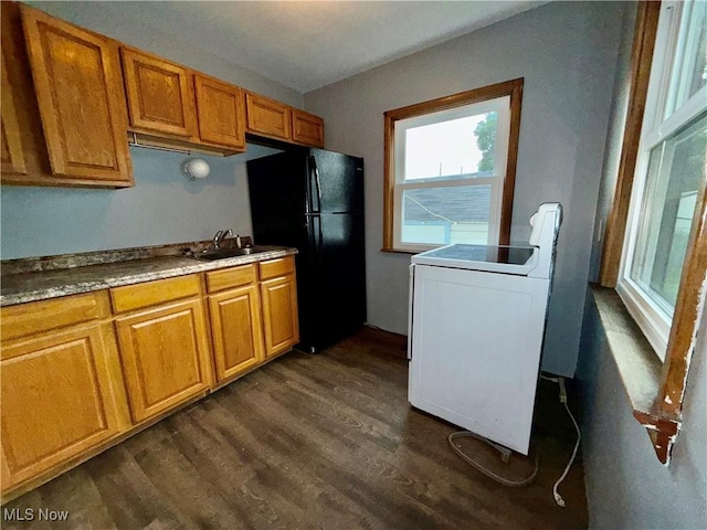 218 Vine St, Coshocton, OH 43812 - kitchen with freestanding refrigerator, dark wood finished floors, brown cabinets, and range