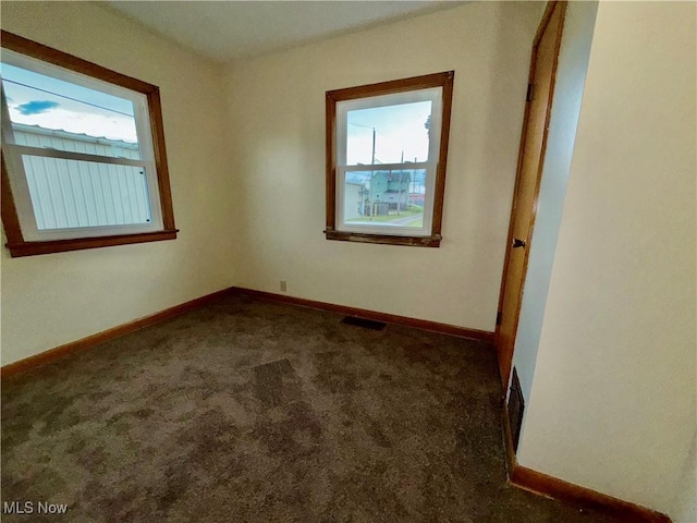 218 Vine St, Coshocton, OH 43812 - carpeted spare room featuring baseboards