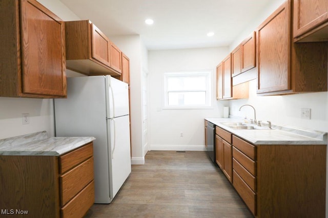 525 Riverside Ave, Wellsville, OH 43968 - kitchen with freestanding refrigerator, dishwasher, light wood finished floors, light countertops, and brown cabinets