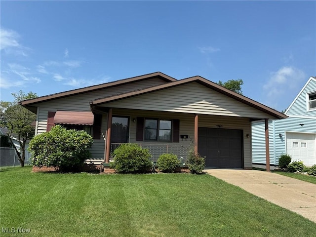 122 N Fairview Ave, Dover, OH 44622 - single story home with a front lawn, an attached garage, concrete driveway, and a porch