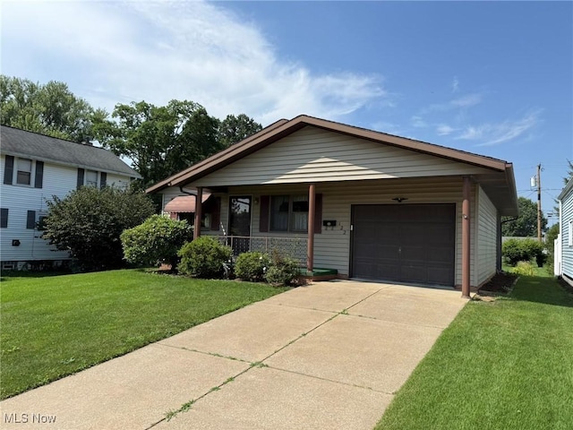 122 N Fairview Ave, Dover, OH 44622 - view of front facade with covered porch, a garage, a front yard, and driveway