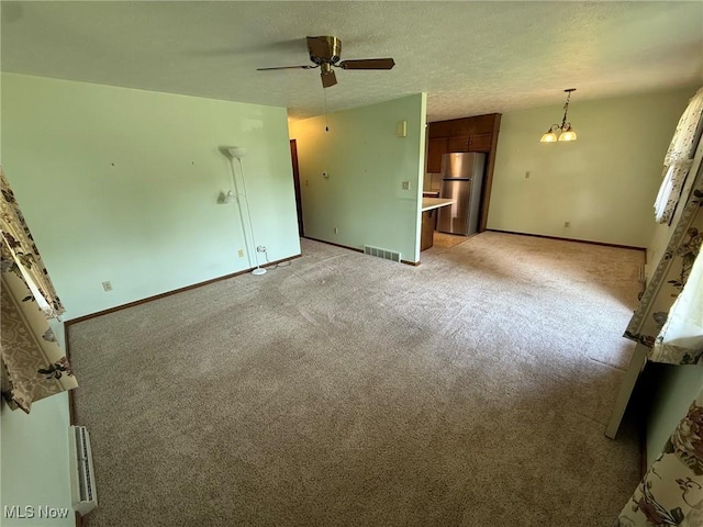122 N Fairview Ave, Dover, OH 44622 - unfurnished living room with ceiling fan, light carpet, and a textured ceiling