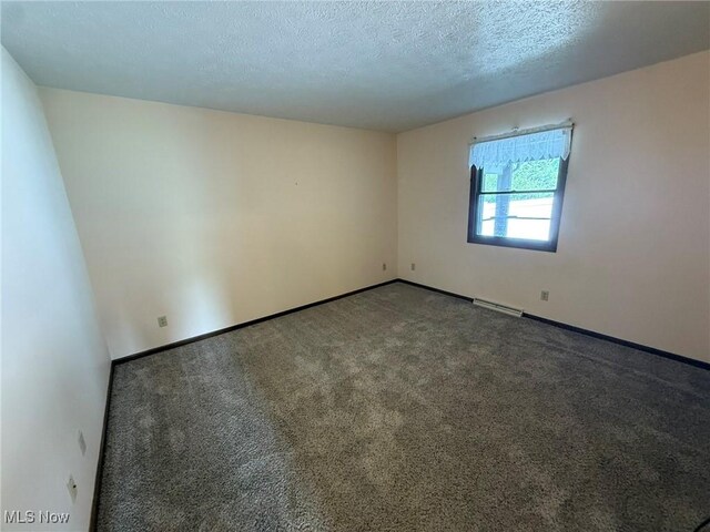 122 N Fairview Ave, Dover, OH 44622 - carpeted empty room featuring baseboards and a textured ceiling