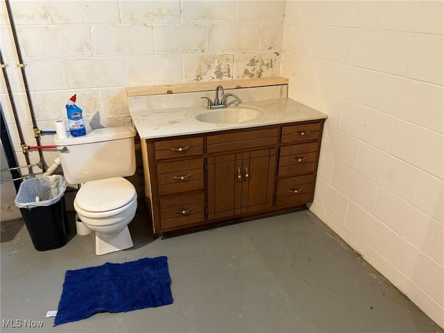 122 N Fairview Ave, Dover, OH 44622 - bathroom featuring finished concrete flooring, vanity, and concrete block wall