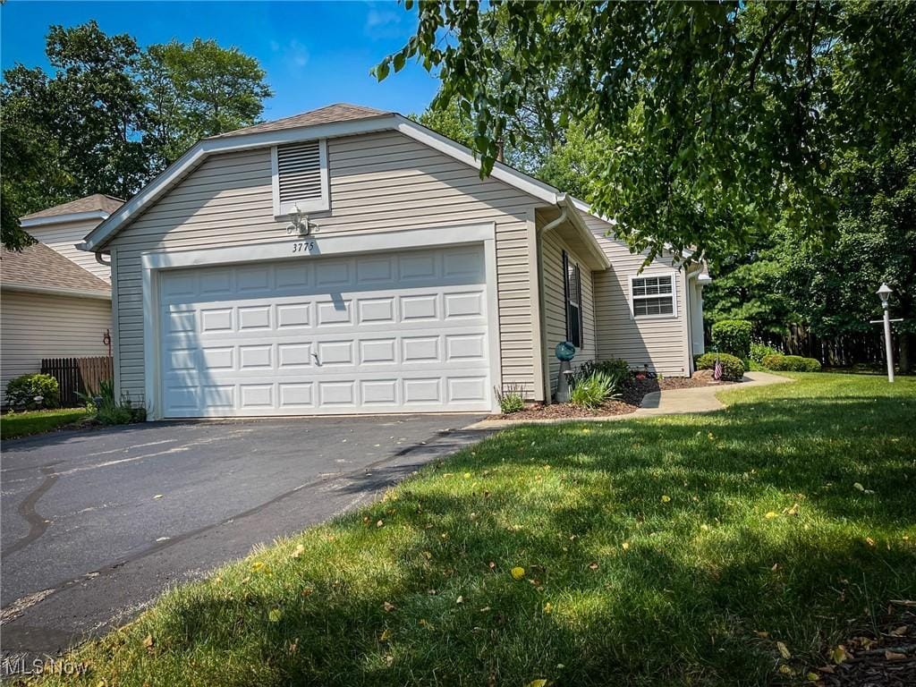 3775 Woodbury Oval, Stow, OH 44224 - view of front facade featuring a garage and a front lawn