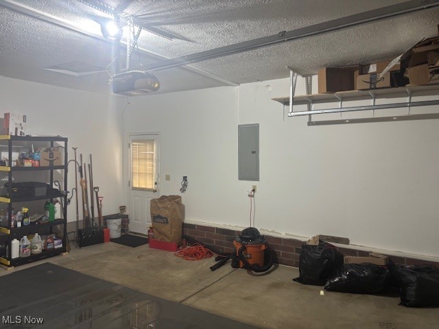 209 Potters Cir, Girard, OH 44420 - garage featuring electric panel and a garage door opener