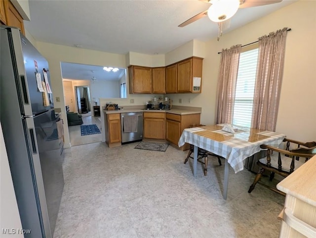 209 Potters Cir, Girard, OH 44420 - kitchen with appliances with stainless steel finishes, ceiling fan, brown cabinetry, and light countertops