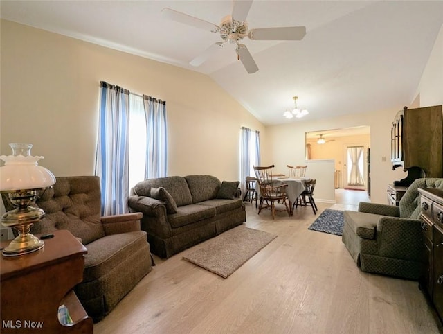 209 Potters Cir, Girard, OH 44420 - living area featuring wood finished floors, vaulted ceiling, a ceiling fan, and a chandelier