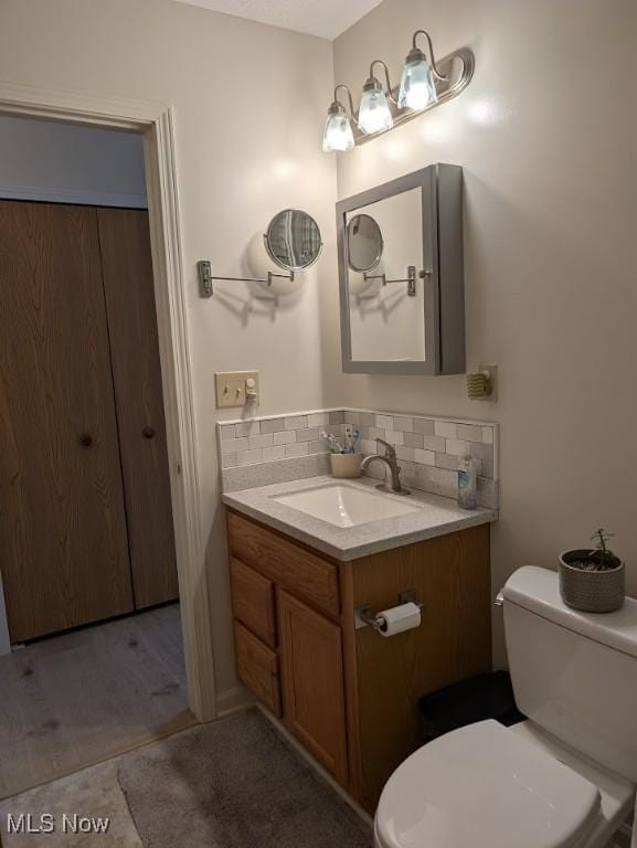 209 Potters Cir, Girard, OH 44420 - half bathroom featuring vanity and decorative backsplash