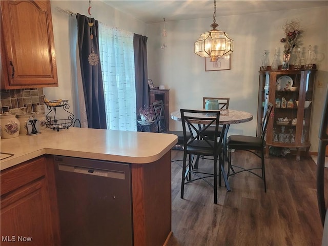 6412 Lieb Dr, New Franklin, OH 44216 - kitchen with stainless steel dishwasher, dark wood-style floors, light countertops, and a peninsula