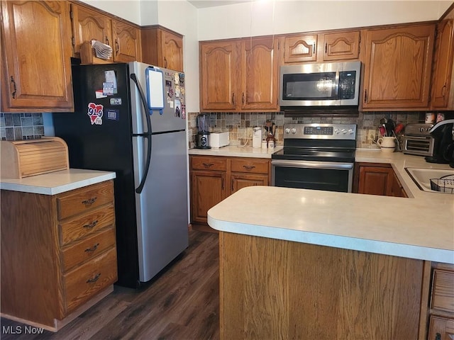 6412 Lieb Dr, New Franklin, OH 44216 - kitchen with appliances with stainless steel finishes, decorative backsplash, light countertops, and dark wood-type flooring