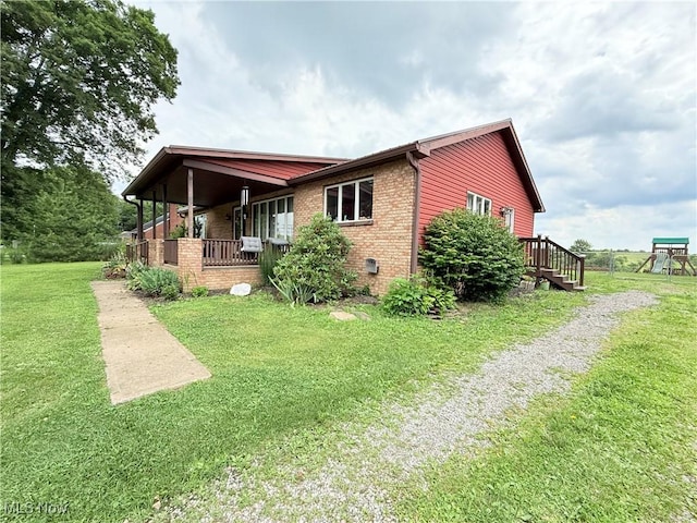 430 County Road 47, Toronto, OH 43964 - view of property exterior featuring a lawn, brick siding, driveway, and a porch