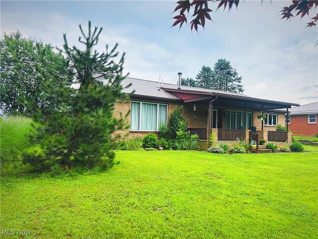 430 County Road 47, Toronto, OH 43964 - rear view of house featuring brick siding, a lawn, and a porch