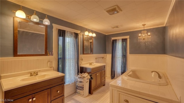 221 N 9th St, Cambridge, OH 43725 - full bath featuring wainscoting, two vanities, a garden tub, crown molding, and tile patterned floors