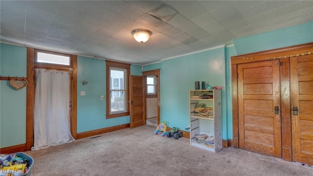 221 N 9th St, Cambridge, OH 43725 - entryway featuring carpet floors and ornamental molding
