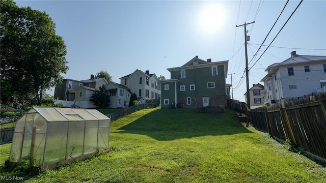 221 N 9th St, Cambridge, OH 43725 - fenced backyard featuring an exterior structure, a residential view, and an outbuilding