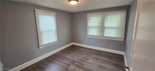 914 Dan St, Akron, OH 44310 - unfurnished room featuring healthy amount of natural light, a textured ceiling, and dark wood finished floors