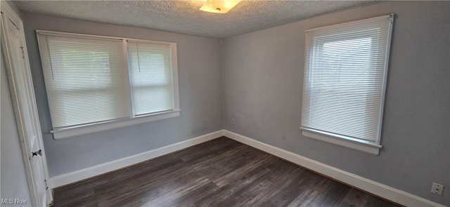914 Dan St, Akron, OH 44310 - unfurnished room featuring a textured ceiling and dark wood finished floors