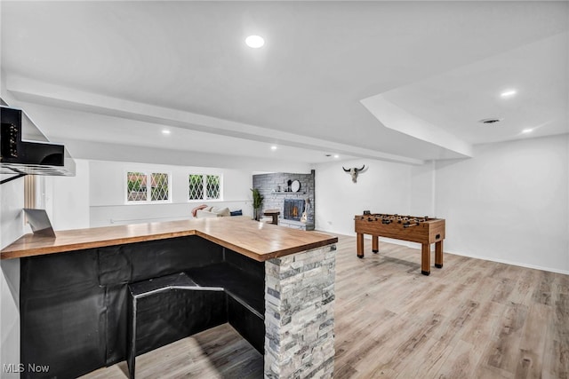 2162 Daniels Ave, Akron, OH 44312 - bar area with light wood-style flooring, recessed lighting, and a warm lit fireplace