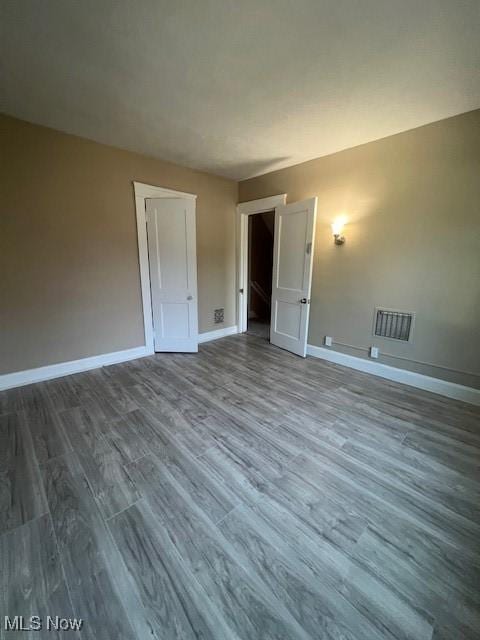 12208 Ingomar Ave, Cleveland, OH 44108 - empty room featuring wood finished floors and baseboards