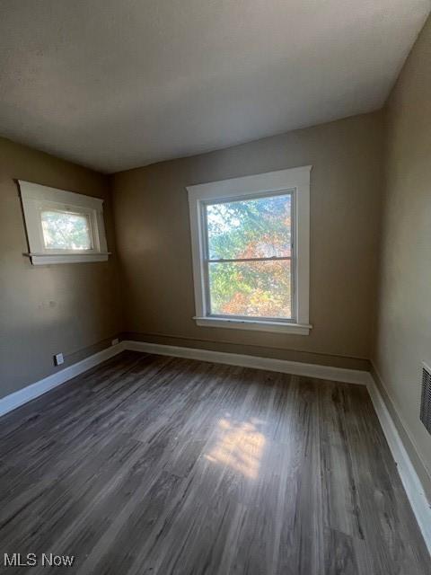 12208 Ingomar Ave, Cleveland, OH 44108 - spare room with dark wood-type flooring and baseboards