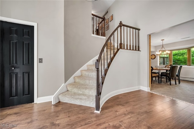 5108 Great Oaks Pkwy, Independence, OH 44131 - entryway featuring wood finished floors, a chandelier, and stairs
