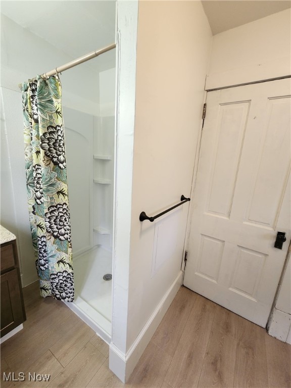 600 Orchard Ave, Cambridge, OH 43725 - full bathroom featuring wood finished floors, a shower stall, and vanity