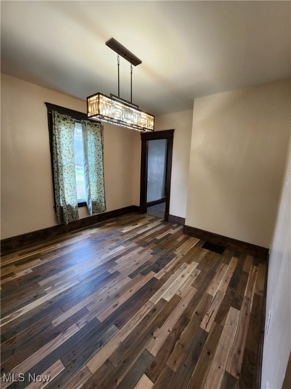 600 Orchard Ave, Cambridge, OH 43725 - unfurnished dining area with dark wood finished floors and a chandelier