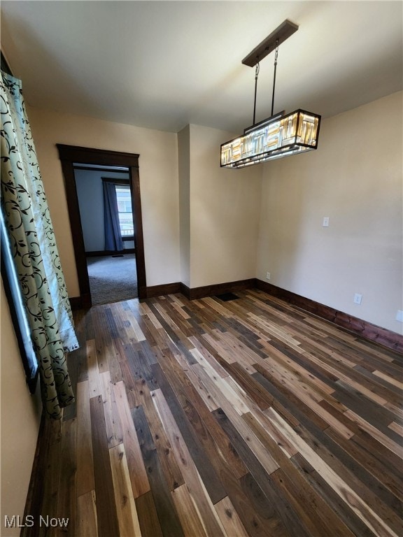 600 Orchard Ave, Cambridge, OH 43725 - unfurnished dining area featuring dark wood-type flooring and a chandelier