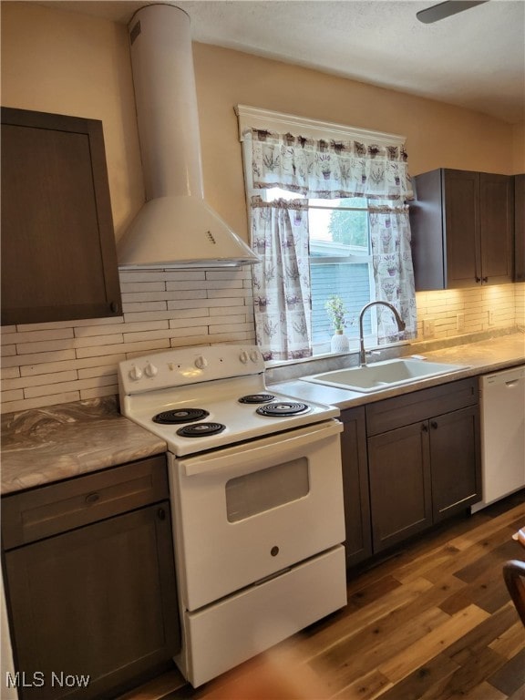 600 Orchard Ave, Cambridge, OH 43725 - kitchen featuring white appliances, wall chimney exhaust hood, light wood-style flooring, decorative backsplash, and light countertops
